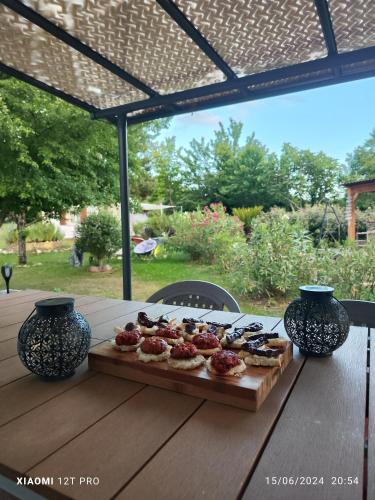 un plateau de nourriture sur une table en bois avec deux vases dans l'établissement LES GORGES DU VERDON chalet, à Riez