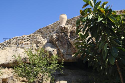 a rock with a chimney on top of it at VILLA NAUTILIA - Luxury Suites and Cottages in Kalafatis