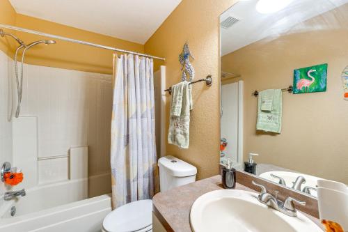 a bathroom with a sink and a toilet and a tub at North Port Home with Charming Lanai about 7 Mi to Beach in North Port