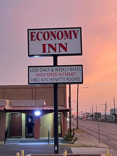 a sign for a economy inn on a street at Economy Inn Odessa in Odessa