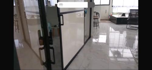 a glass door in a room with a hallway at Heinz B. in Santa Ana de los Caballeros