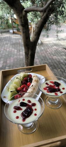 two plates of food with fruit on a table at Vila D in Berat