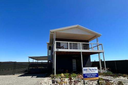 a house with a sign in front of it at Casa De Praia - Entire Home - North Beach in Wallaroo