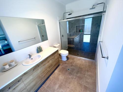 a bathroom with a shower and a sink and a toilet at Casa De Praia - Entire Home - North Beach in Wallaroo