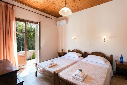 a bedroom with a large bed and a large window at Villa Stemal in Acharavi