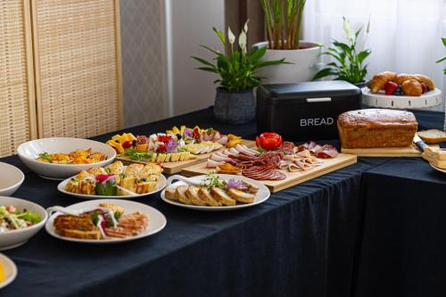 a table with many plates of food on it at Hotel Kopczyński in Dobre Miasto