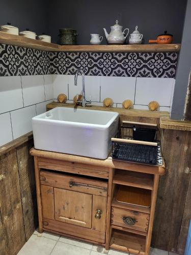 a white sink on a wooden counter in a kitchen at The Seaside Hideaway St Leonards in Hastings