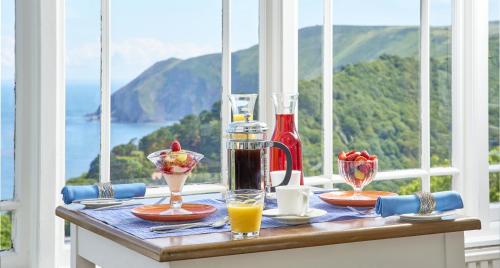 a table with drinks on it with a view of the ocean at Highcliffe House in Lynton