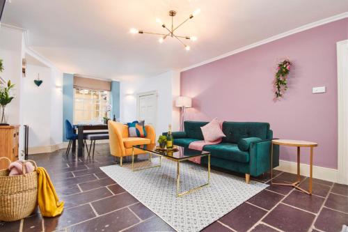 a living room with a green couch and chairs at Beautiful 2 Bedroom 3 actual beds House with WiFi by PureStay in Bath