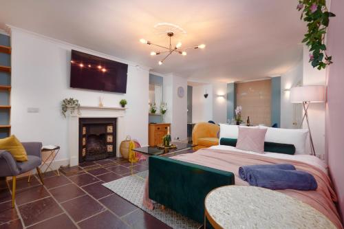 a bedroom with a large bed and a fireplace at Beautiful 2 Bedroom 3 actual beds House with WiFi by PureStay in Bath