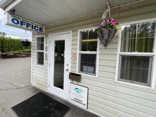a building with a flower pot on the side of it at Fraser Bridge Inn in Quesnel