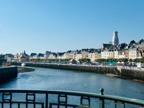a view of a river with a city in the background at Cosy Appart - Plage à 2min - Casino à 1min in Trouville-sur-Mer