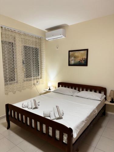 a bedroom with a large bed with white sheets and pillows at Brand New Apartament Durres in Durrës