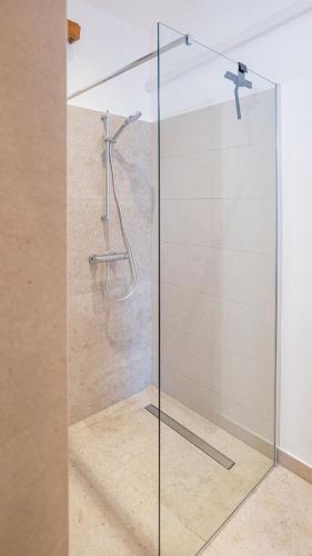 a glass shower door in a bathroom at Oleander House in Lumbarda
