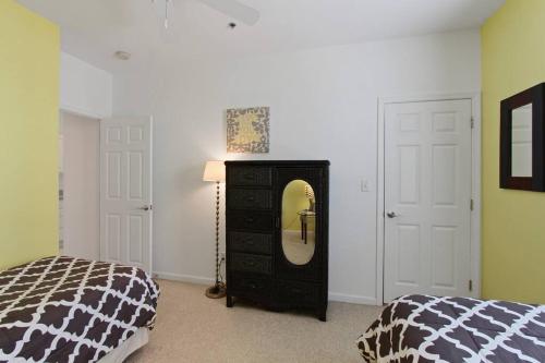 a bedroom with a dresser with a mirror and a bed at Rehoboth Beach Home that has It All in Rehoboth Beach
