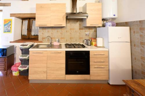 a kitchen with a white refrigerator and a sink at Relax a casa Beba in Reggello