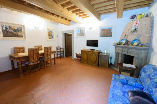 a living room with a table and a fireplace at Relax a casa Beba in Reggello