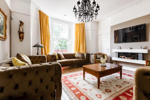 a living room with couches and a coffee table at Grand Victorian Villa 6 - En-Suites, Hot Tub, Cinema Room, Private Parking & Park View in Liverpool