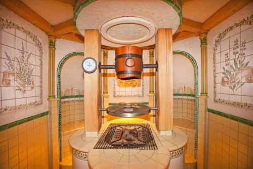 a bathroom with a bath tub with a dog in it at Hotel Yastrebets Wellness & Spa in Borovets