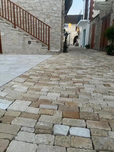 a stone walkway with a staircase in a building at Stin Avli tou Pavlou Guest House in Omodos