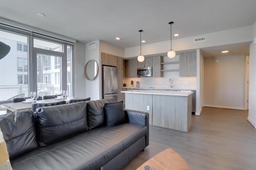 a living room with a couch and a kitchen at Quiet Apartment Steps from the Subway at Clarendon in Arlington