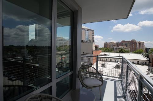 a balcony with a chair and a view of a city at Quiet Apartment Steps from the Subway at Clarendon in Arlington