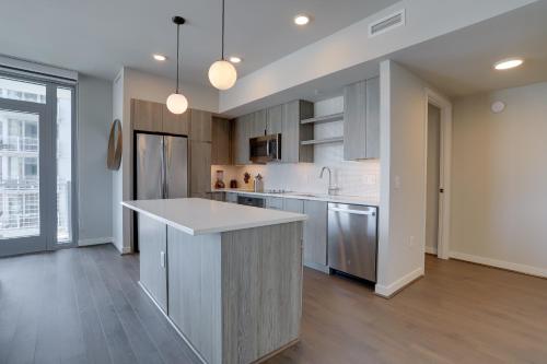 a kitchen with a large island in the middle at Quiet Apartment Steps from the Subway at Clarendon in Arlington