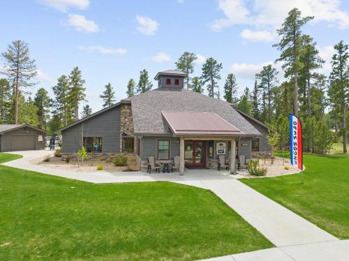 a house with a flag in the grass at The Cottonwood in Lead