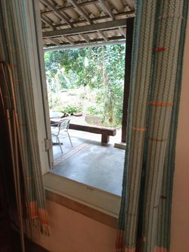 a window with a view of a table and a bench at Casa Grande Flats in Abraão