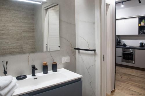 a bathroom with a white sink and a mirror at AMarescaladeiturchy Valle dei templi in Realmonte