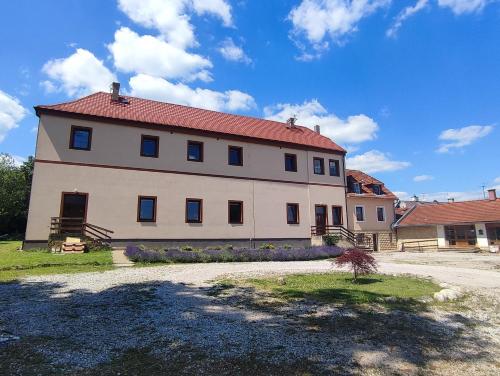 a large white house with a red roof at Zámeček Čeřov in Jičín