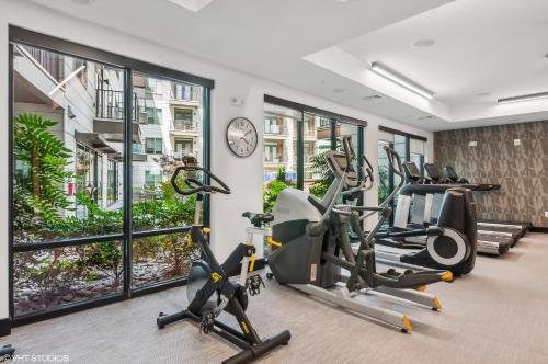 a gym with treadmills and elliptical machines at Kasa Noda Charlotte in Charlotte