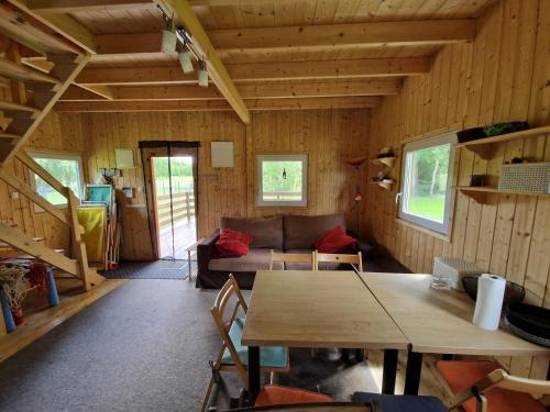 a living room with a couch and a table at Domek u Jędrka in Linowo