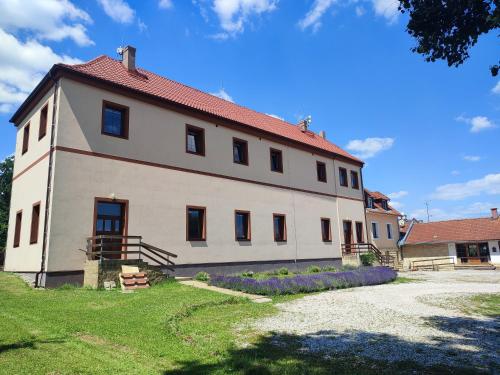 a large white building with a red roof at Zámeček Čeřov in Jičín