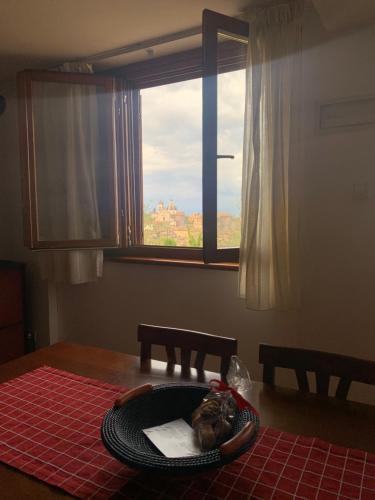 a cat sitting in a bowl on a table with a window at Lucy house in Ronciglione
