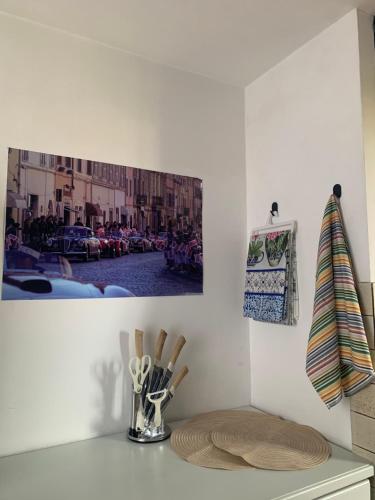 a kitchen counter with a table with a picture on the wall at Lucy house in Ronciglione