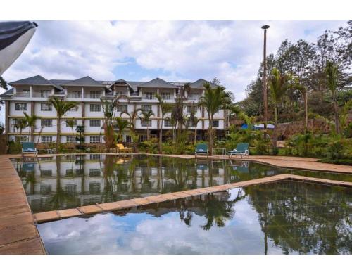 a hotel with a pool in front of a building at Tobriana in Nairobi