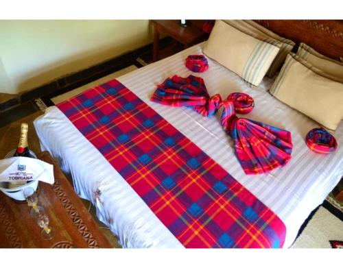 a bed with bow ties on top of it at Tobriana in Nairobi