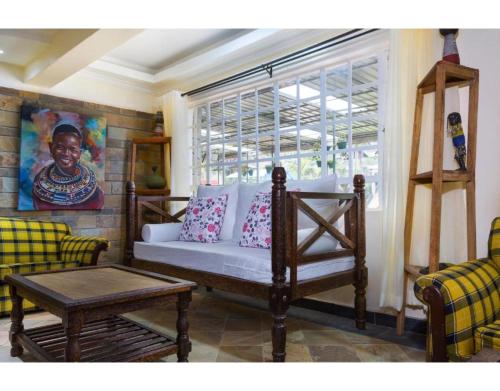 a living room with a bed and a window at Tobriana in Nairobi
