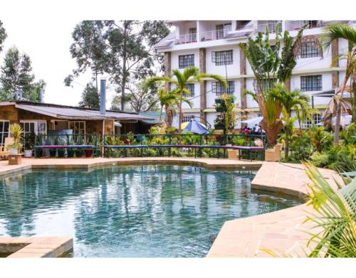 a swimming pool in front of a building at Tobriana in Nairobi
