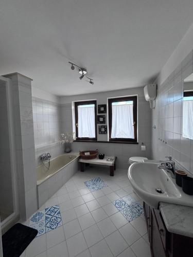 a white bathroom with a tub and a sink at Lucy house in Ronciglione