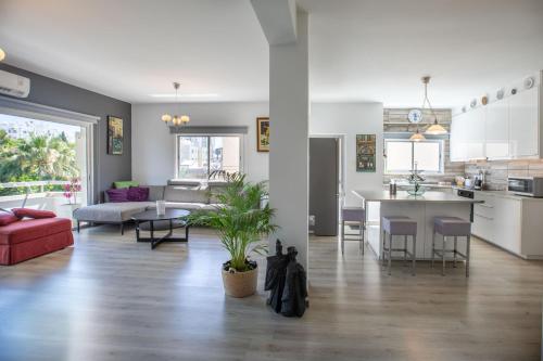 a living room with a kitchen and a dining room at Neapolis Residence Spacious Quiet Near beach in Limassol
