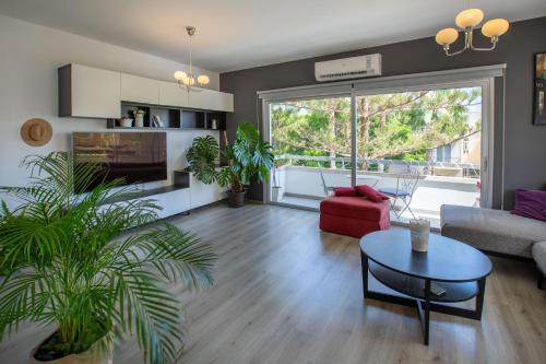 a living room with a couch and a table at Neapolis Residence Spacious Quiet Near beach in Limassol