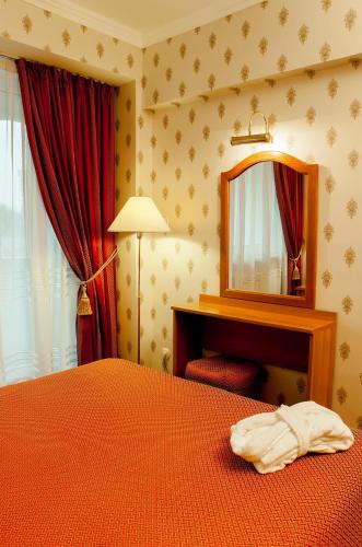 Postel nebo postele na pokoji v ubytování Astana International Hotel