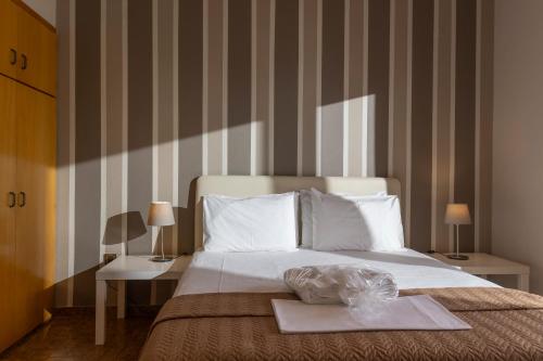a bedroom with a bed with a tray on it at Sea View Apollo Apartments & Studios in Afytos in Afitos