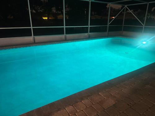 an empty swimming pool at night at BLD Vacation Residences in West Palm Beach