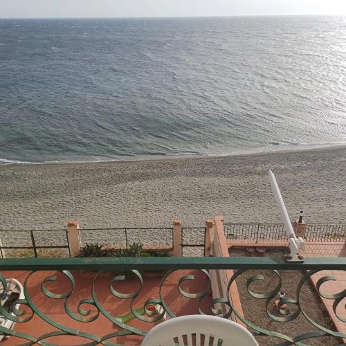 a balcony with a view of the beach at Ionio in Reggio Calabria