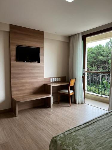 Televisyen dan/atau pusat hiburan di Vista Azul Apart Hotel Suites
