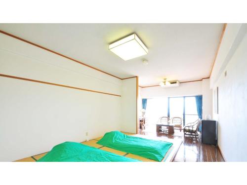 a room with two beds and a television in it at Umibe no Kajuen - Vacation STAY 17475v in Konan