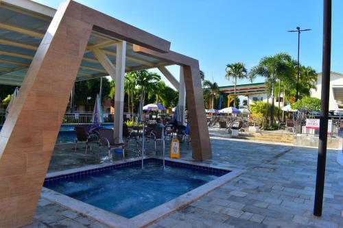 a swimming pool in a pavilion with a swimming pool at OFERTA - Fiori DiRoma Caldas Novas - Térreo - Parque Aquático 24h in Caldas Novas